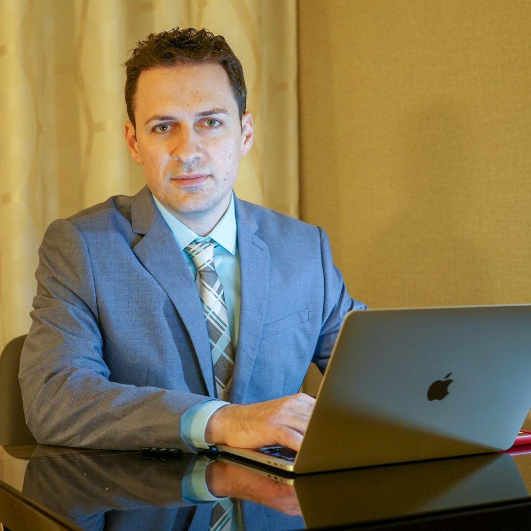 Professional portrait of a man in business casual attire