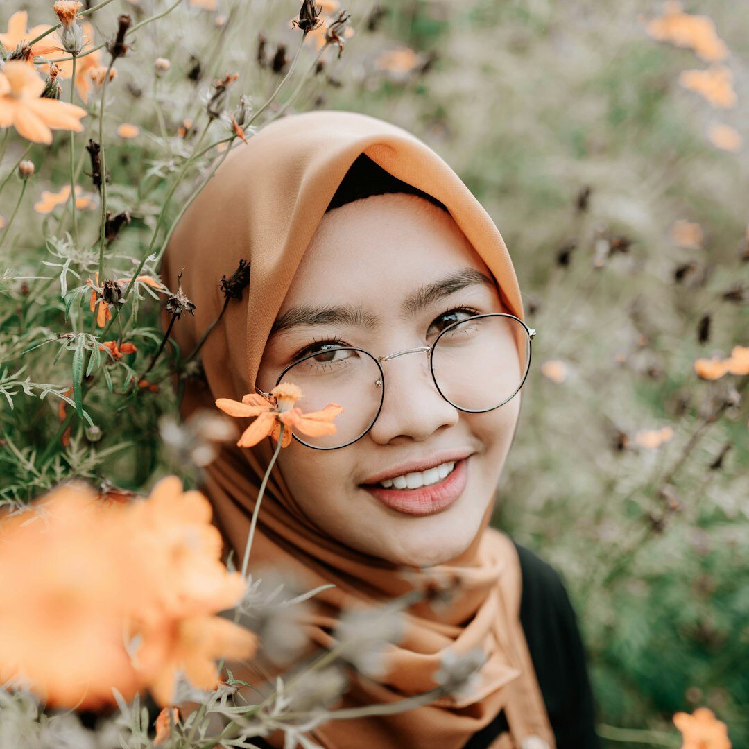 Professional portrait of a woman with glasses smiling