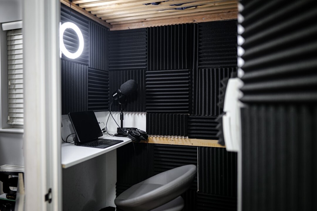 Podcast studio with microphone and acoustic panels at night