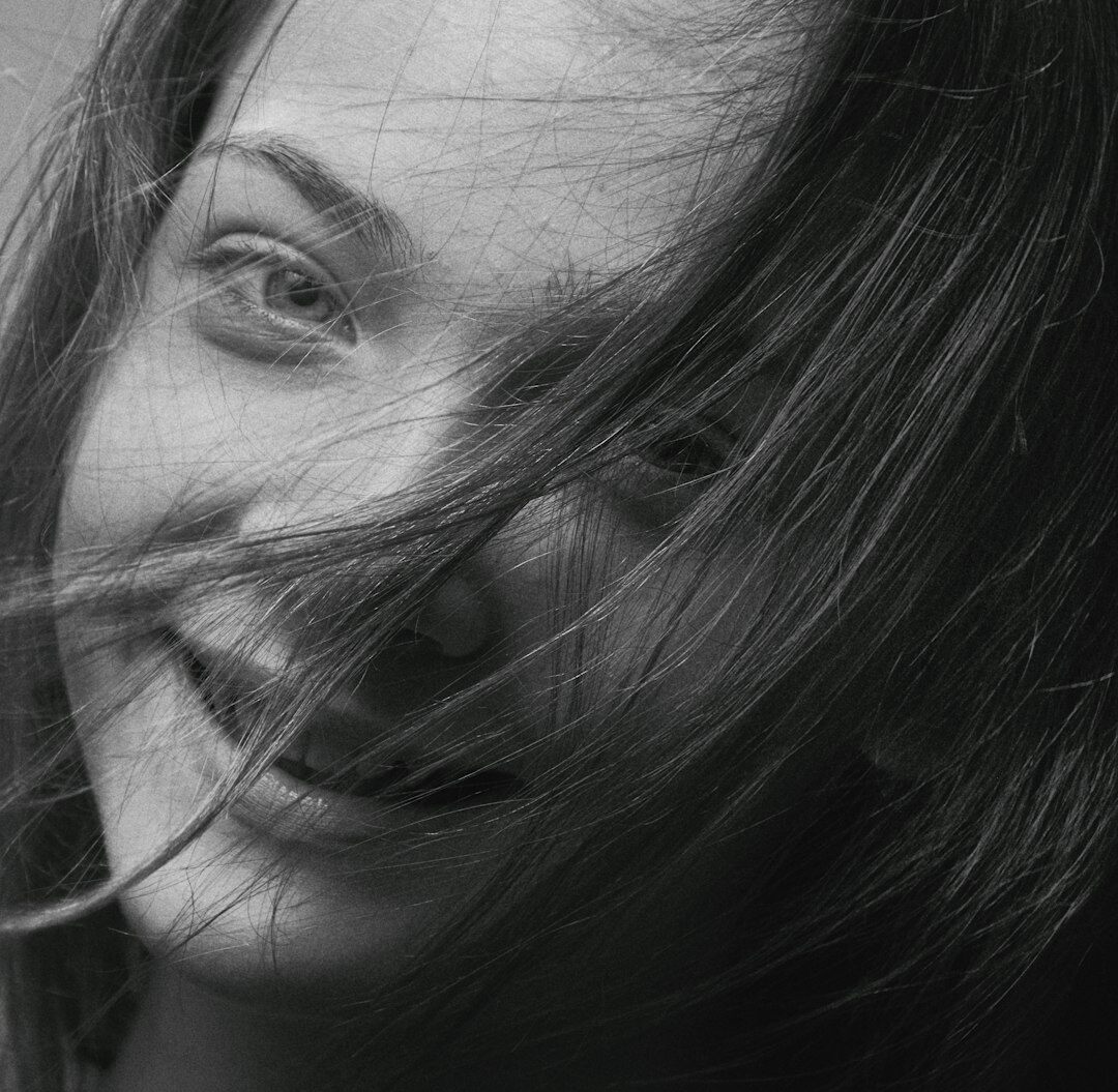 Professional portrait of a young woman smiling warmly